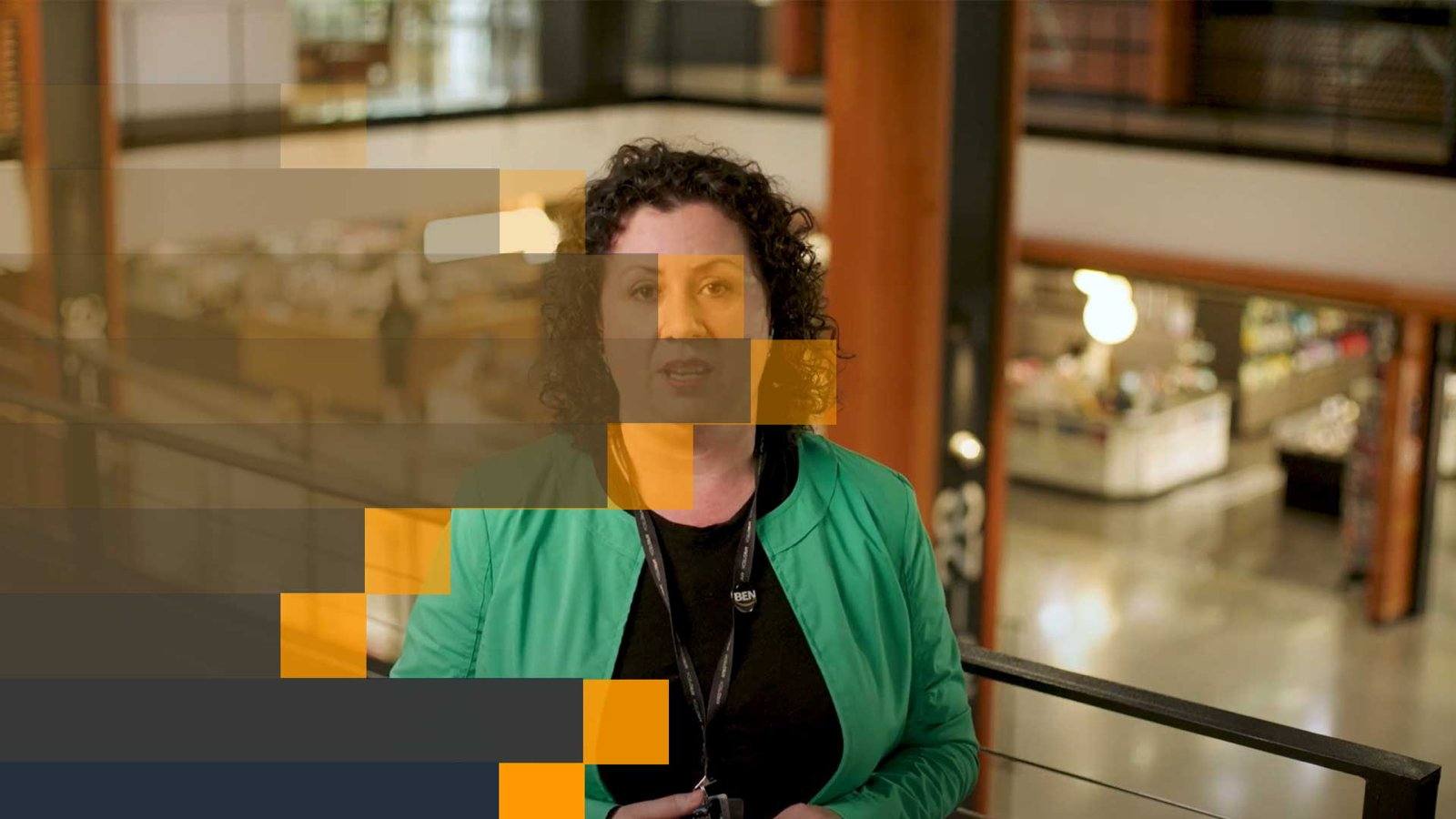 Transition design over interview footage: dark navy arrow shapes wipe across the frame