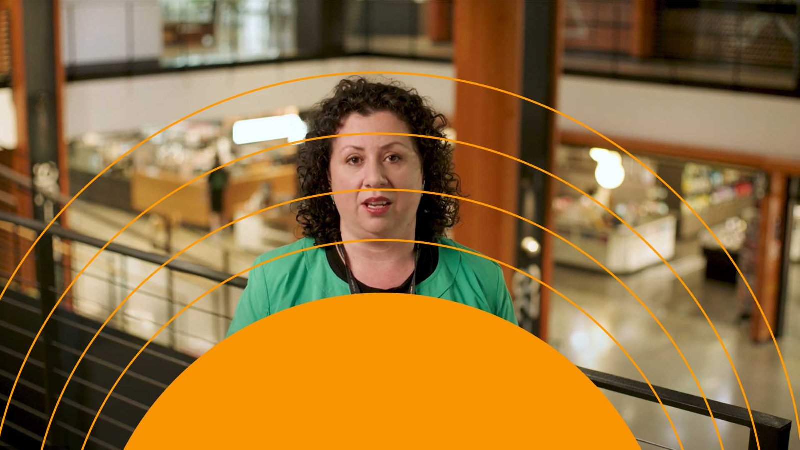 Transition design: an orange half circle and fine rings rise under the speaker