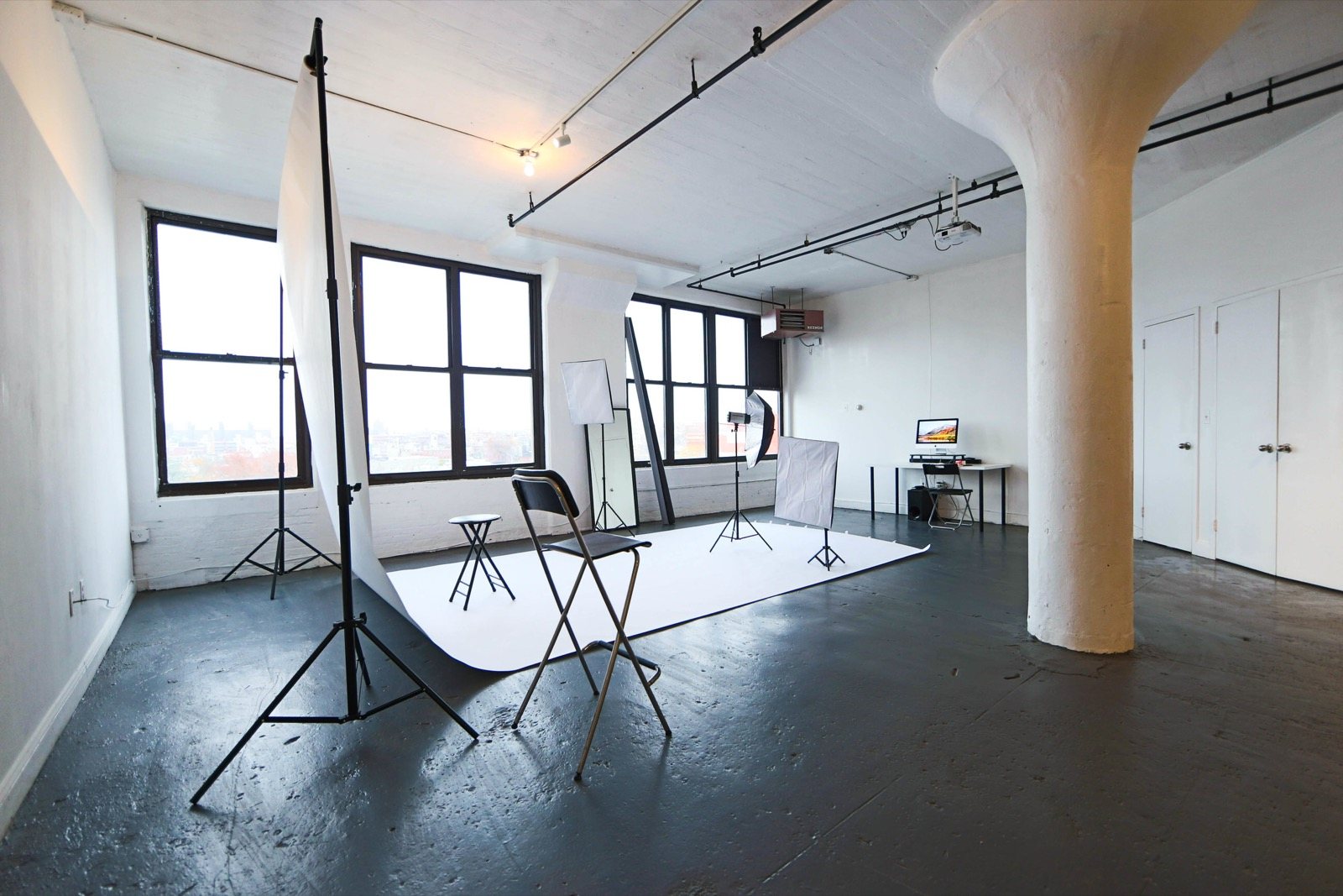 The 24:Ours loft in Downtown Brooklyn, a white photo studio with lighting stands