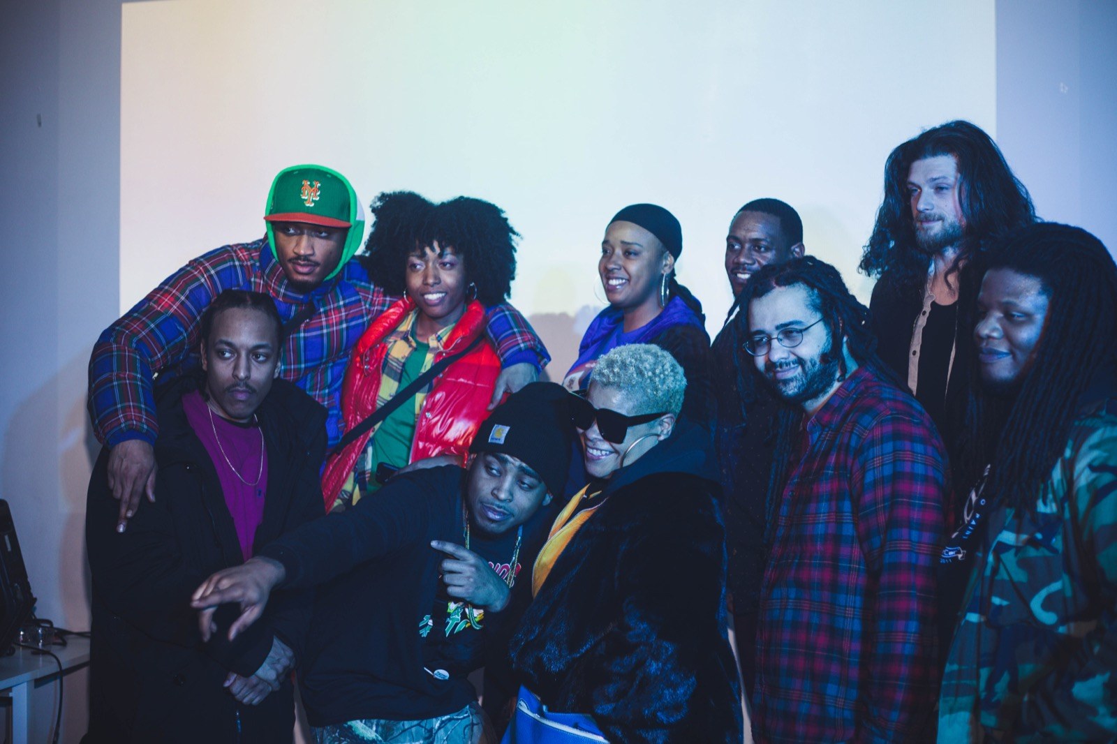 Guests and artists gathered for a group photo at a loft show