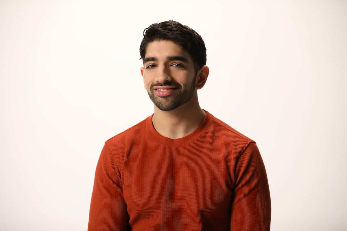 A smiling man in a rust red sweater, from the LetsGetChecked photoshoot